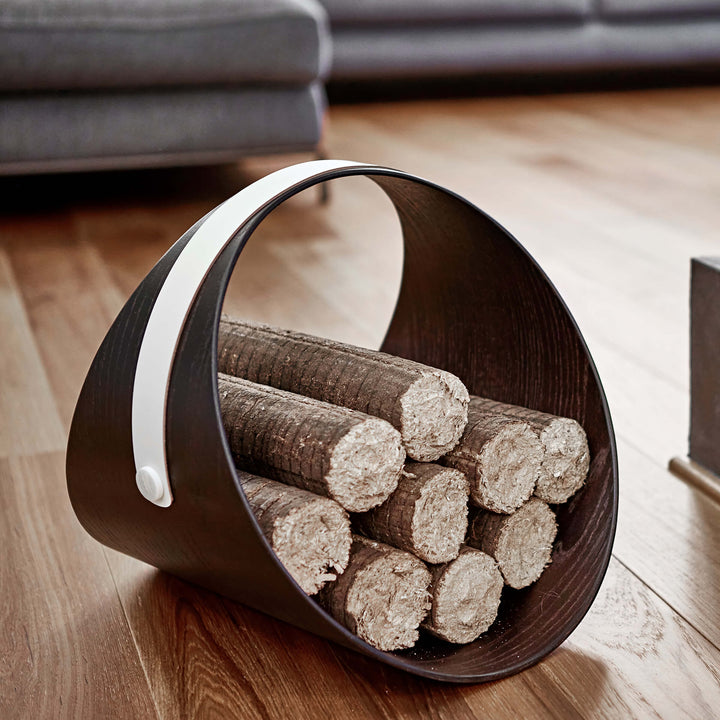 Wooden holder with logs on a wooden floor