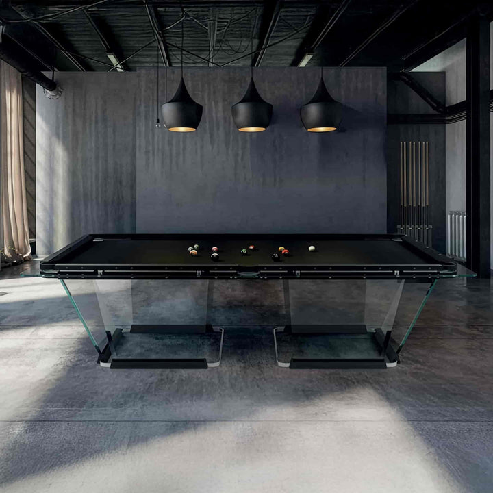 Modern glass pool table in a dimly lit room with dark walls and pendant lights.