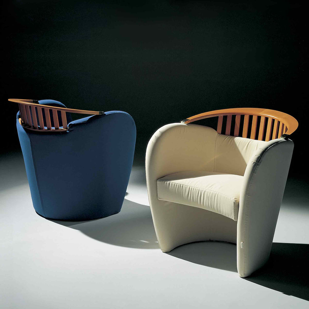 Cream and blue Nausica armchairs by Giovannetti with curved wooden slatted backrests, shown from front and rear.