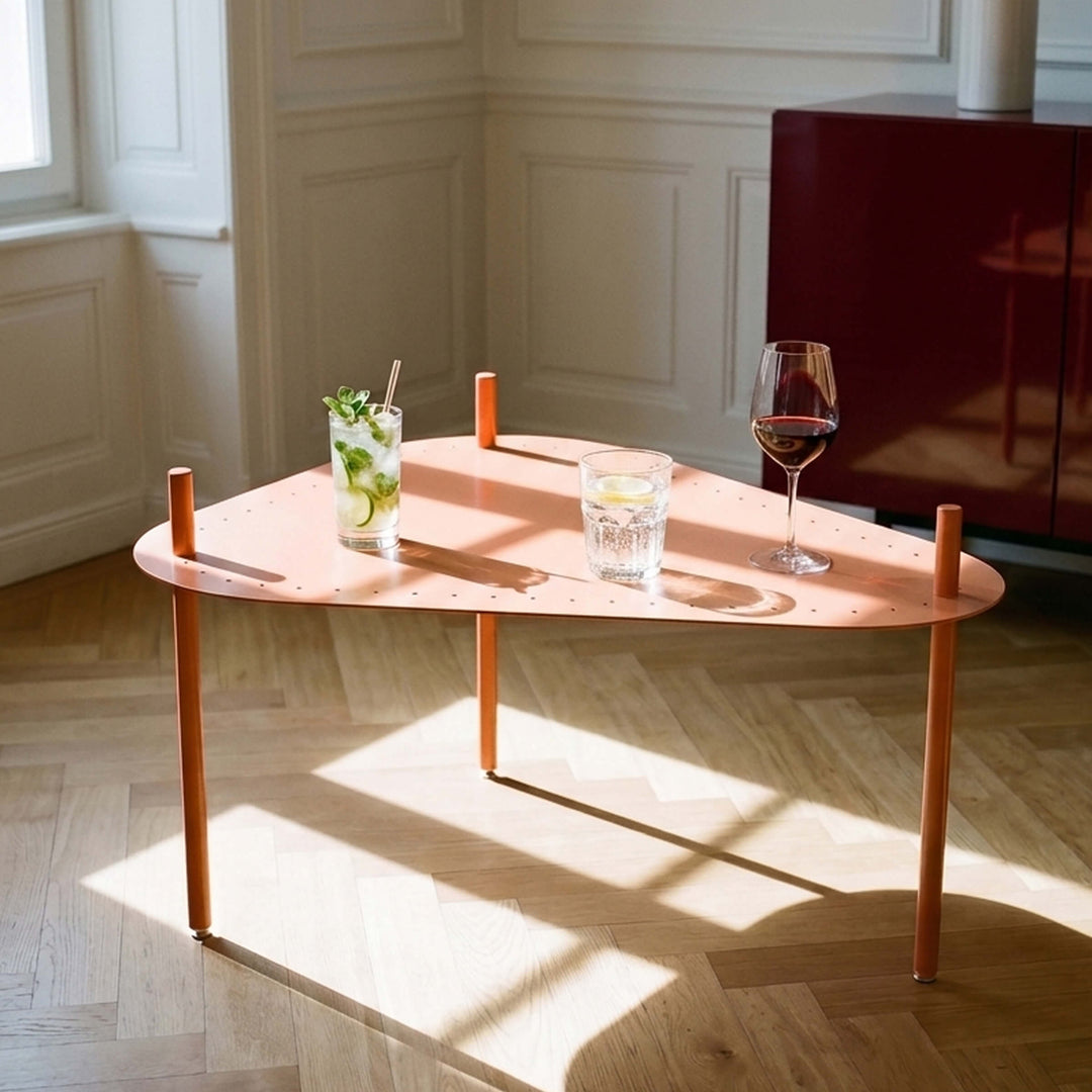 Giacopini BEA 08 melon coffee table with a rounded triangular top holding three drinks in a sunlit room