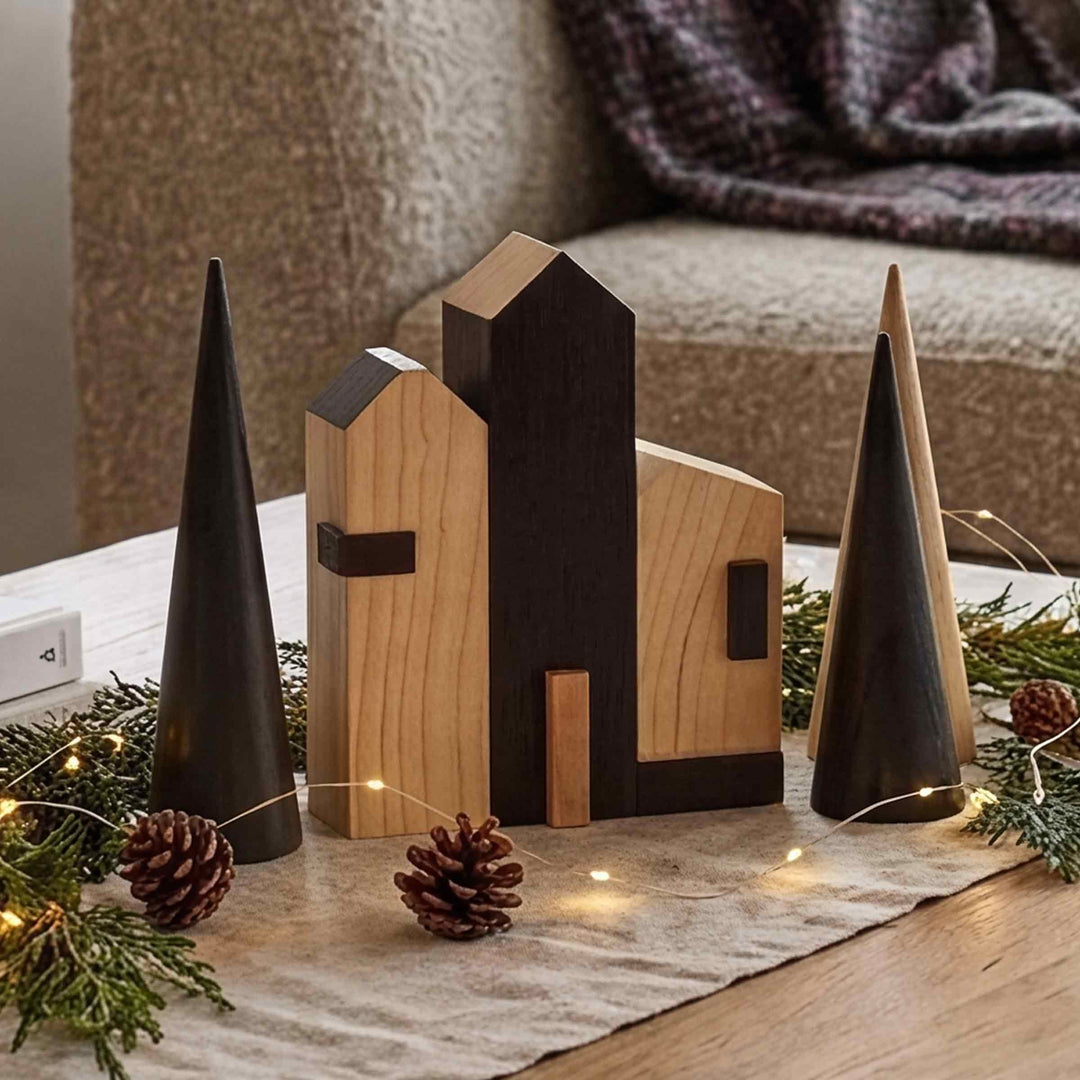 Cities Rotterdam wooden houses and cone-shaped trees on a table runner with pine cones, evergreen branches and fairy lights