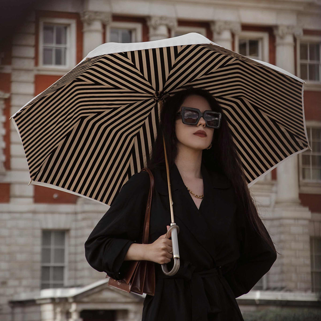 Ivory umbrella with acetate handle by Pasotti, elegant luxury rain accessory.