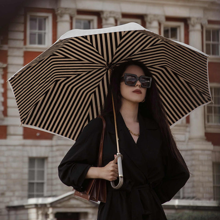 Ivory umbrella with acetate handle by Pasotti, elegant luxury rain accessory.
