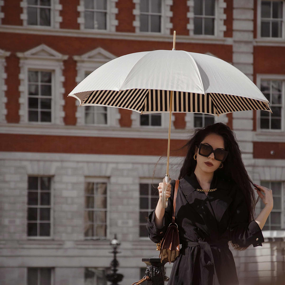 Ivory umbrella with acetate handle by Pasotti, elegant luxury rain accessory.