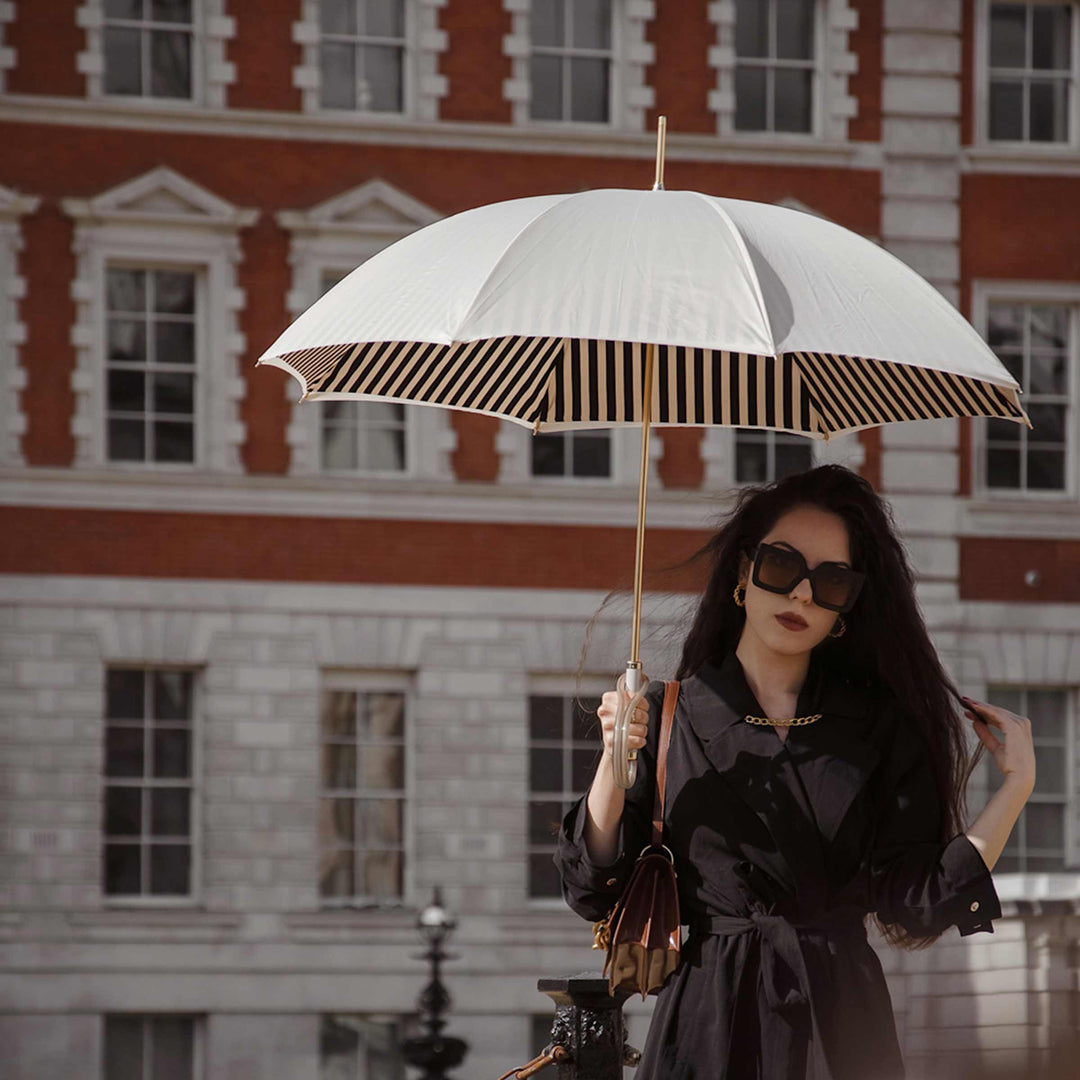 Ivory umbrella with acetate handle by Pasotti, elegant luxury rain accessory.