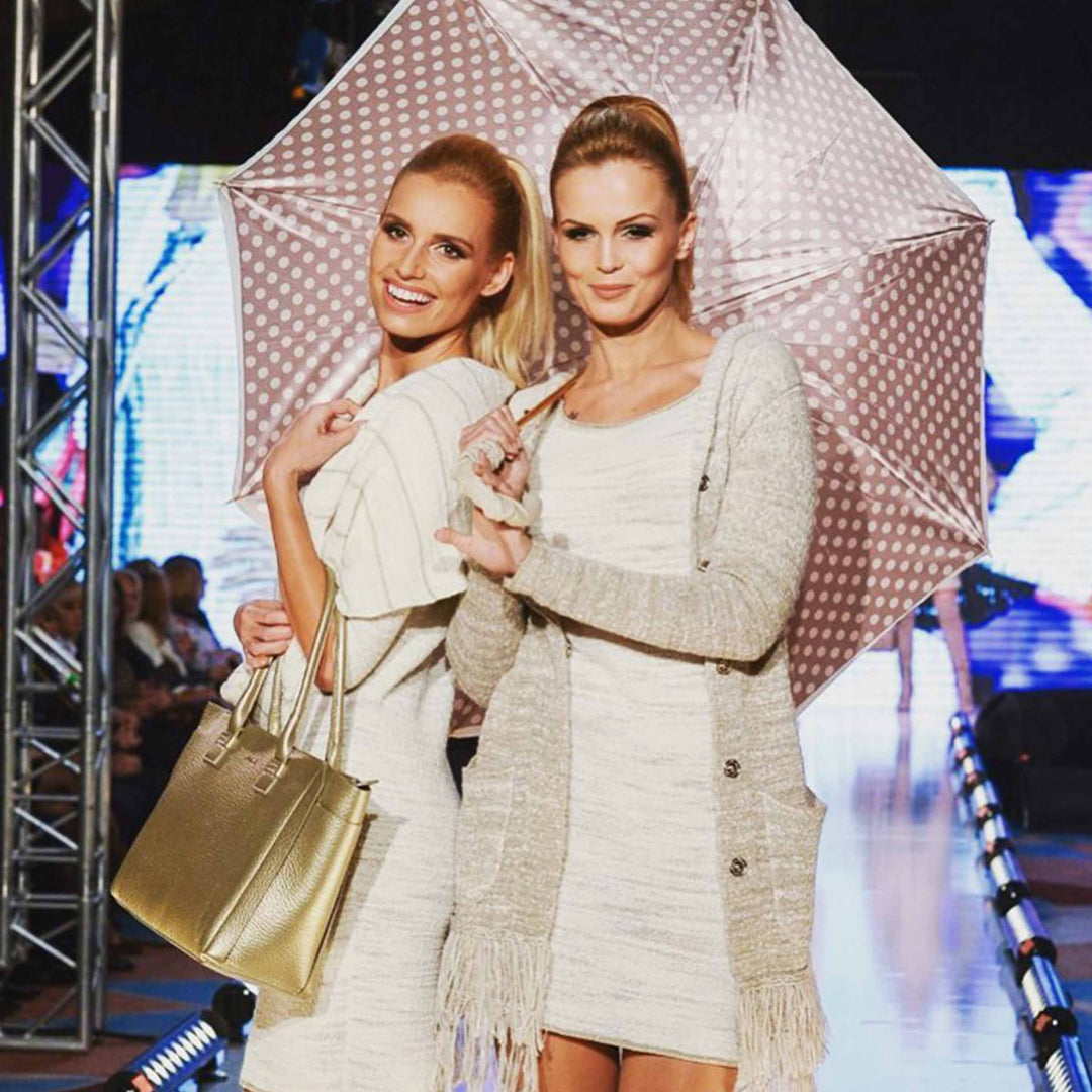 Ivory umbrella with leather handle, elegant luxury rain accessory.