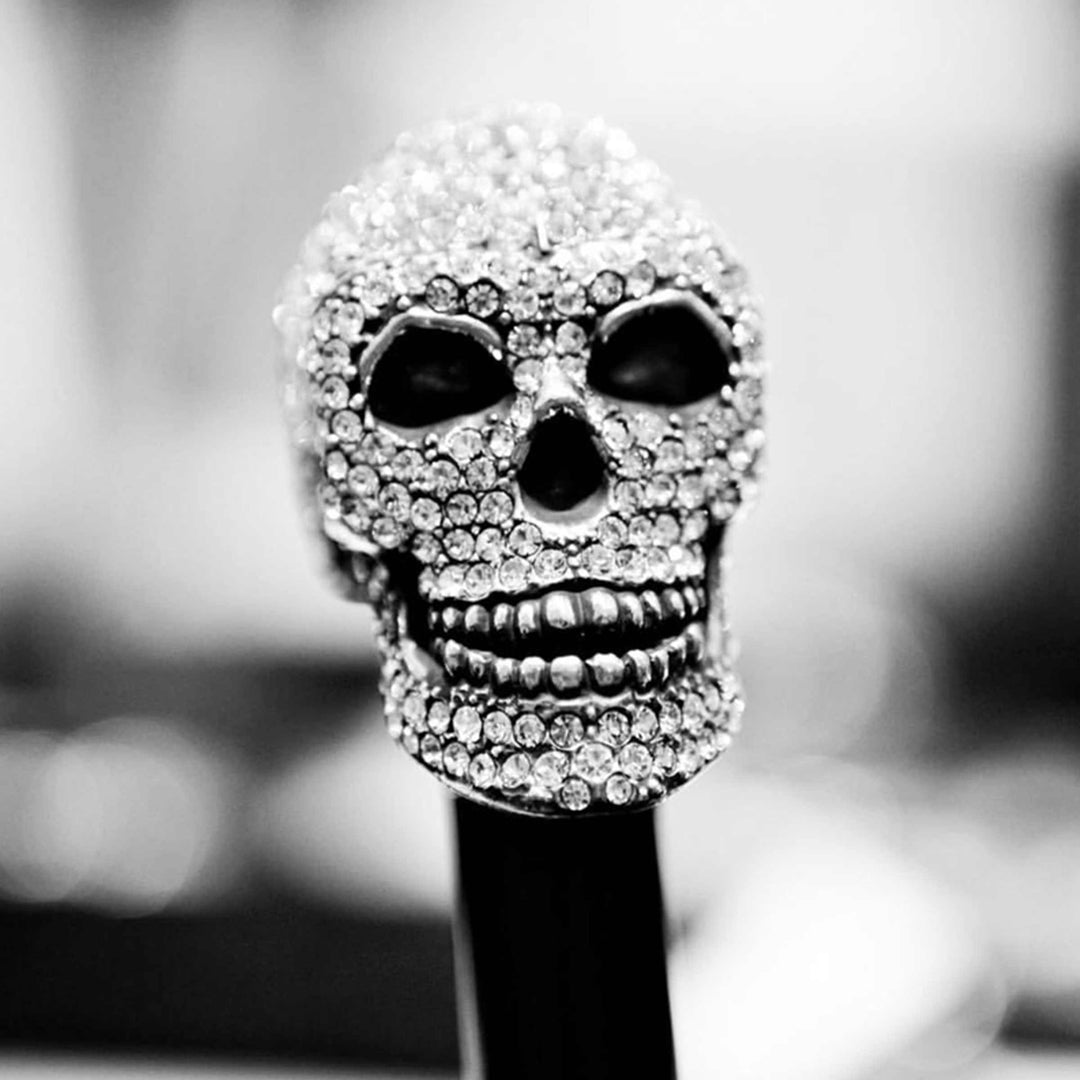 Skull umbrella with Swarovski crystal handle, luxury designer rain accessory.